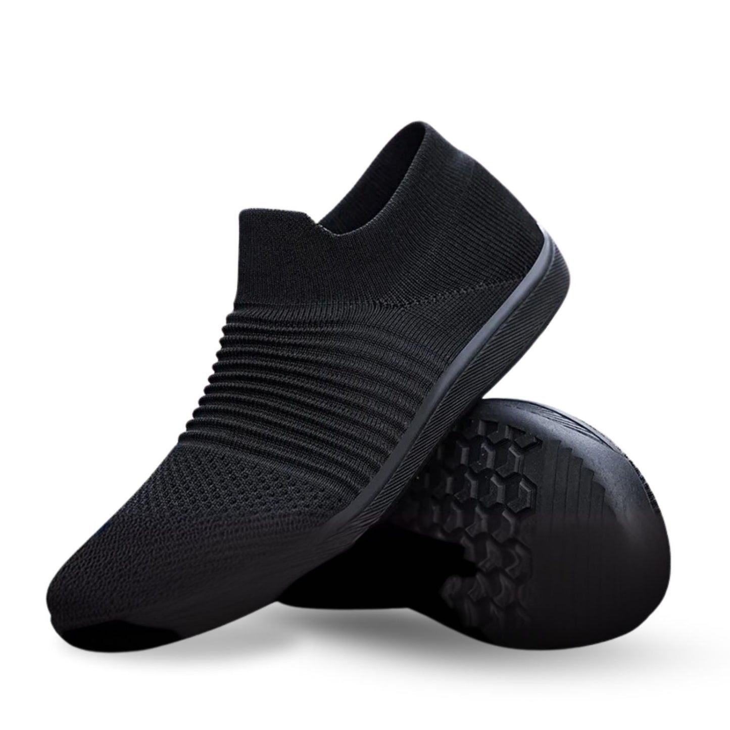 Black slip-on knit sneaker with ribbed texture, shown with flexible outsole detail.