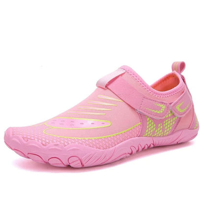 Pink water shoe with yellow accents and velcro strap, shown from side angle.