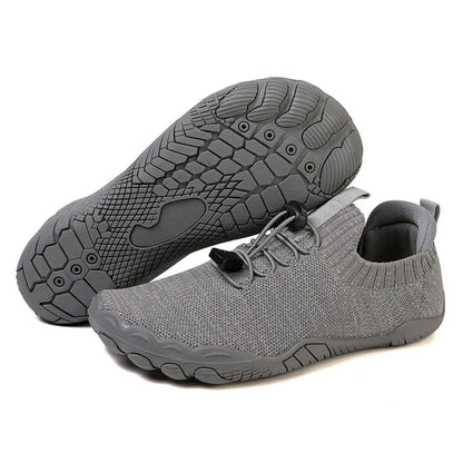Gray barefoot shoe with knit upper and black textured sole, shown from side and bottom view.