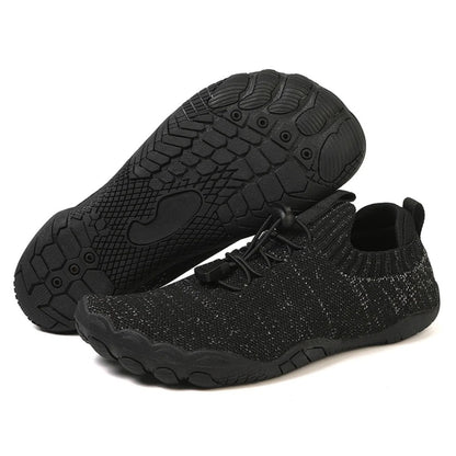 Black minimalist barefoot shoe with durable treaded sole, shown side and bottom.