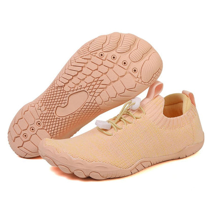 Beige barefoot shoes with textured sole and elastic lacing, shown side by side.