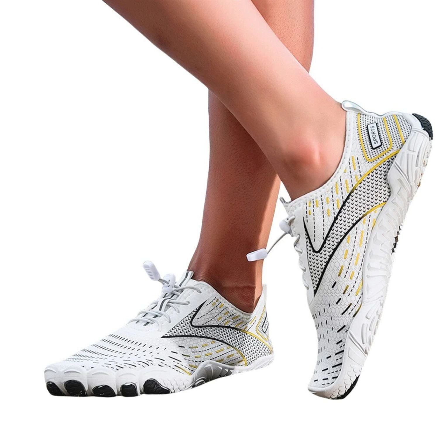 Person wearing white barefoot water shoes with yellow and black details, standing on one leg.