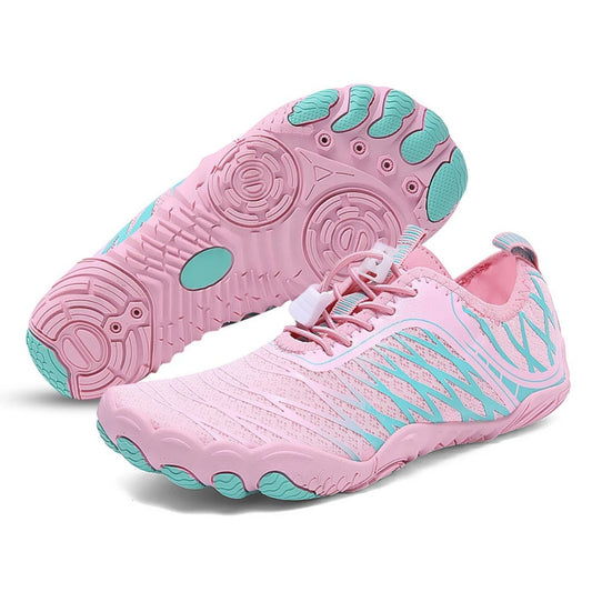 Pink barefoot shoe with aqua green circular-grip sole and side mesh pattern, shown from side and bottom view.