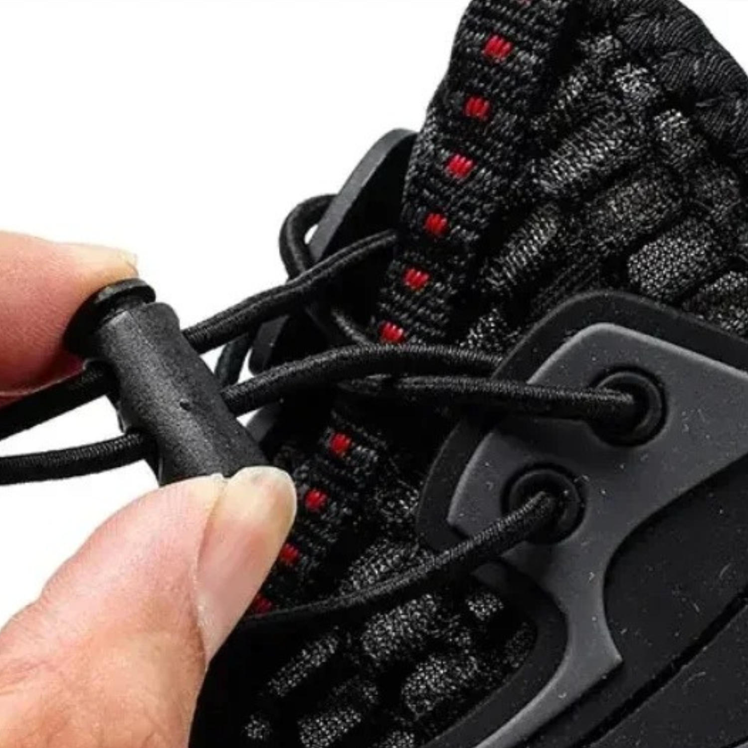 Close-up of adjustable drawstring toggle system on black water shoe.