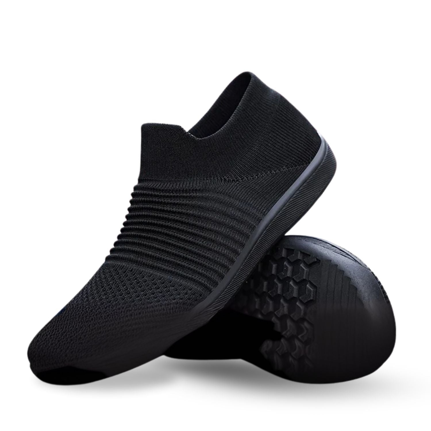 Black slip-on knit sneaker with ribbed texture, shown with flexible outsole detail.