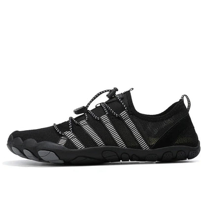 Black barefoot water shoe with gray accents and striped elastic laces, side profile.