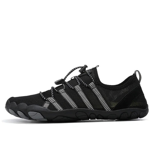 Black barefoot water shoe with gray accents and striped elastic laces, side profile.