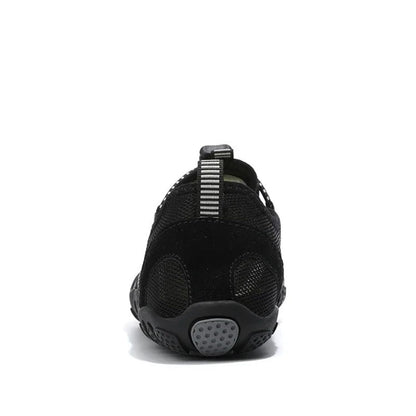 Back view of black barefoot water shoe with pull tab and gray heel detail.