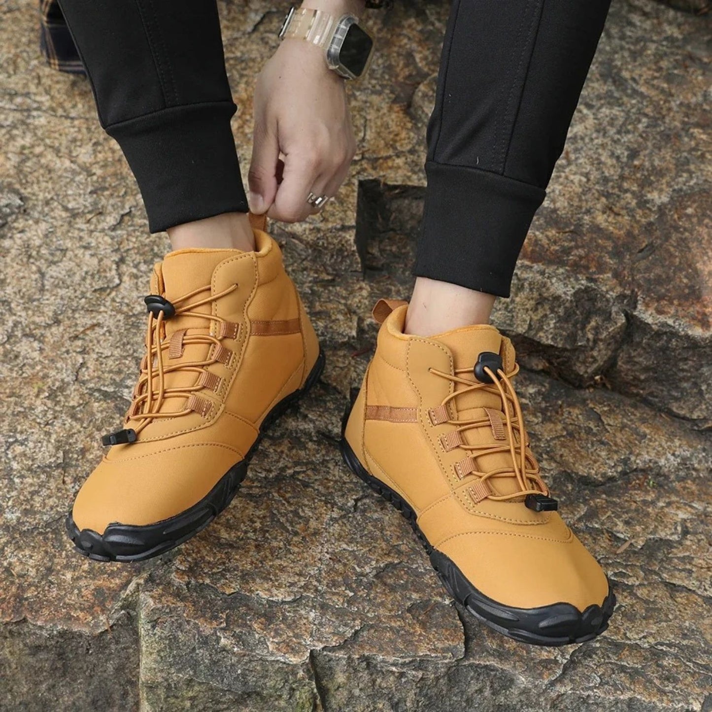 Brown outdoor hiking boots with ankle support worn while walking on trail.
